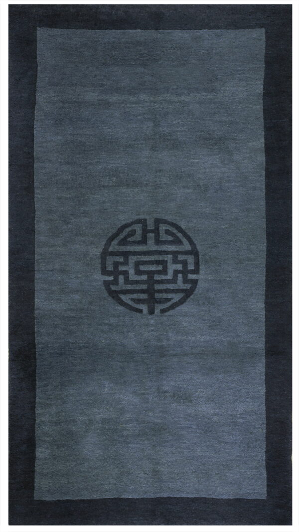A dark slate runner rug featuring a darker border and a central circular geometric medallion.