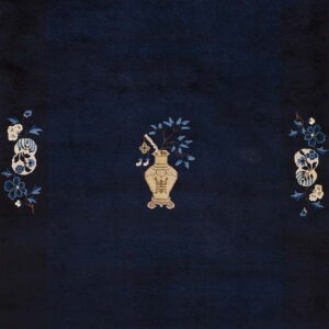 A deep navy blue rug detailed with a stylized tan vase, blue leaves, and pale floral corner patterns.