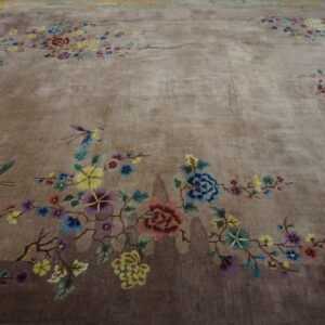 High pile brown rug featuring an asymmetrical design of multicolored flowers and butterflies on a neutral field.