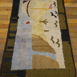 Chunky hooked rug depicting a sailboat and birds, framed by olive and black stripes, on wood planks.