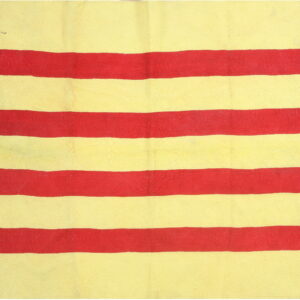 The rug shows wide, textured horizontal stripes in bright yellow and bright red.