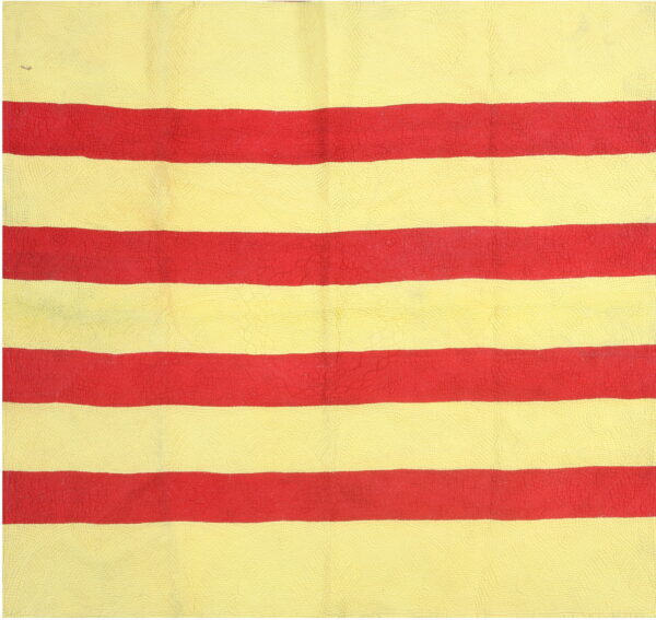 The rug shows wide, textured horizontal stripes in bright yellow and bright red.
