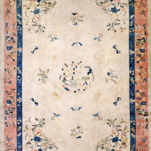 Low-pile rug with a cream field, pink and blue borders, and scattered stylized floral designs.