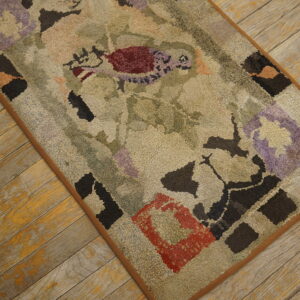 Textured beige rug featuring abstract red, purple, and dark block patterns lies on distressed yellow wood planks.