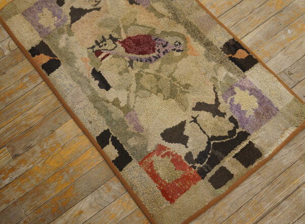 Textured beige rug featuring abstract red, purple, and dark block patterns lies on distressed yellow wood planks.