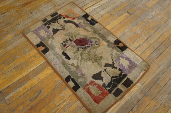 Textured, multicolored abstract rug in muted tones of green, beige, red, and lavender on rustic wood flooring.