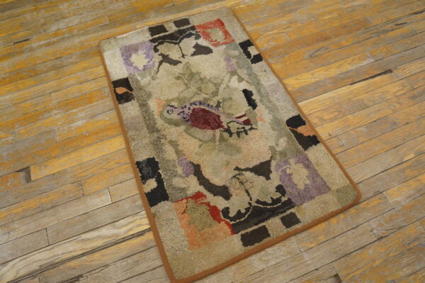 A looped rug featuring beige, purple, red, and black abstract designs rests on rustic wooden planks.