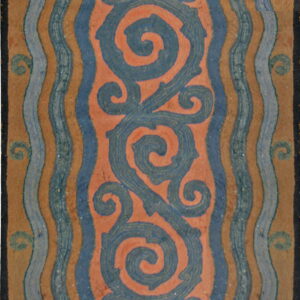 Rug displays large blue serpentine scrolls on a coral field, flanked by vertical wavy blue and tan stripes.