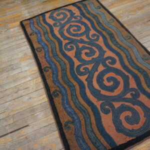 Rustic rug with navy scrolls and brown, blue, rust wavy stripes on distressed wood planks.