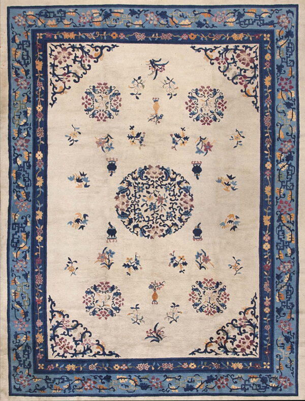 Light beige rug with scattered multicolored floral motifs and intricate multi-toned blue borders.