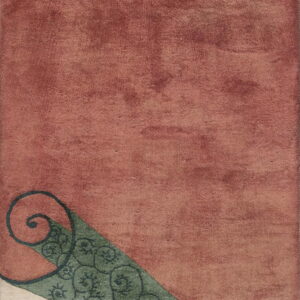 Geometric rug with rust and cream color blocks separated by a teal wedge with dark, spiraling motifs.