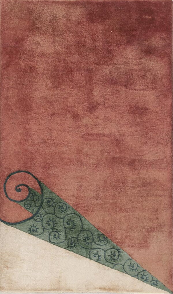 Geometric rug with rust and cream color blocks separated by a teal wedge with dark, spiraling motifs.