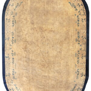Oblong beige rug with a faint field pattern and a distinctive dark blue scrolling border and edge.