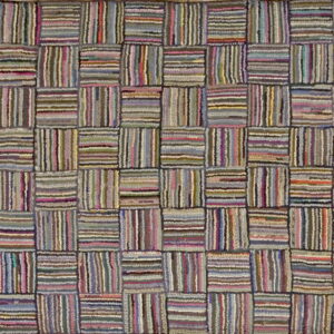 High-texture multicolored rug showing a grid of striped blocks in purple, pink, gray, and green.
