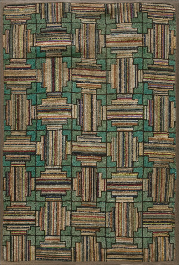 Geometric hooked rug with teal interlocking pattern surrounding multicolored striped block shapes.