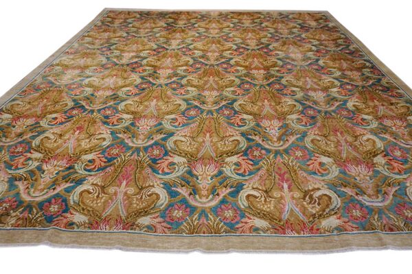 Golden brown and teal rug with intricate symmetrical motifs and accents of rose pink.
