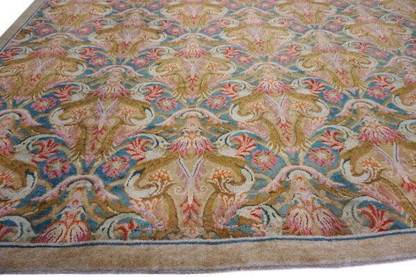 Intricate floral rug design featuring teal, beige, pink, and gold color tones.