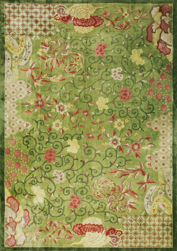 Vibrant lime green rug featuring an all-over design of scrolling vines, red flowers, and patterned corner panels.