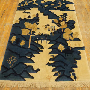 Blue and gold scenic landscape runner rug featuring mountains, trees, and pagodas on a light wood floor.