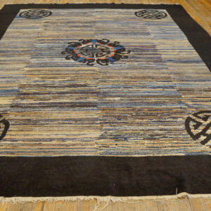 Low-pile rug with a dark border and striped blue and tan field, featuring traditional black medallions.
