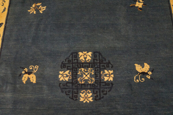 Wool hand knotted pile rectangle antique blue ivory beige cream white 1920s rug 11 Deep blue rug with a golden floral medallion detailed in black fretwork and surrounded by small motifs.