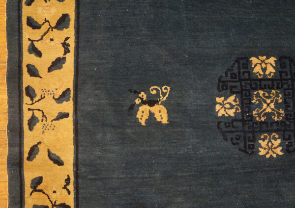 Wool hand knotted pile rectangle antique blue ivory beige cream white 1920s rug 12 Dark blue rug with gold border and dark floral vine patterns, featuring gold butterfly and medallion motifs.