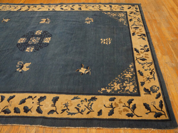 Wool hand knotted pile rectangle antique blue ivory beige cream white 1920s rug 6 Deep indigo rug with a wide tan and dark blue floral border laid over a wood floor.