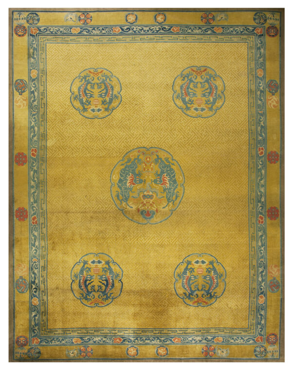 Saffron yellow rug with repeating fretwork, five blue dragon medallions, and ornate teal and red borders.