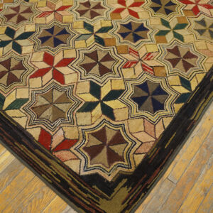 Textured rug featuring repeating multicolored star motifs bordered in dark brown on light wood floors.
