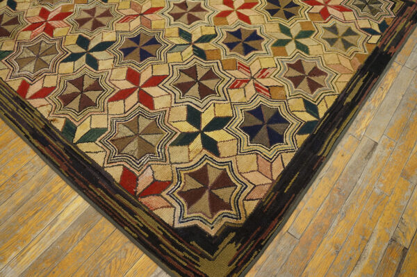 Textured rug featuring repeating multicolored star motifs bordered in dark brown on light wood floors.
