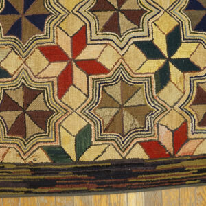 Textured rug with interlocking red, blue, and brown star geometric pattern visible on hardwood floor.