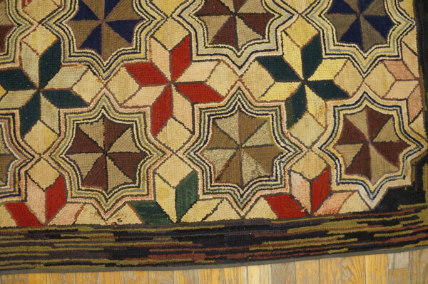 Textured rug with interlocking red, blue, and brown star geometric pattern visible on hardwood floor.