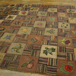 A large, textured patchwork rug with alternating squares of floral designs and multicolored stripes rests on wood flooring.