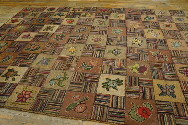A large, textured patchwork rug with alternating squares of floral designs and multicolored stripes rests on wood flooring.