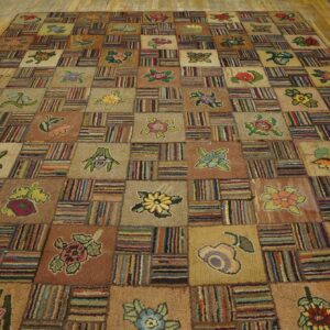Earthy-toned patchwork rug with floral motifs and dense striped sections rests on light wooden floorboards.