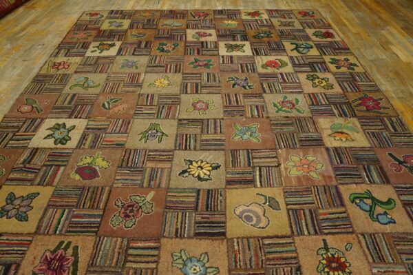 Earthy-toned patchwork rug with floral motifs and dense striped sections rests on light wooden floorboards.
