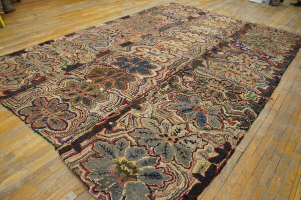 Textured multicolored rug displaying large stylized floral patterns on light wood plank flooring.