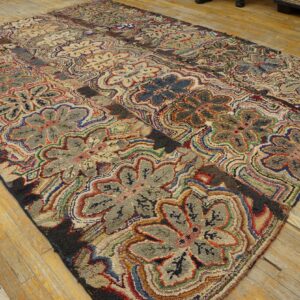 Polychromatic high-pile rug with gray and tan floral motifs displayed on distressed light wooden planks.