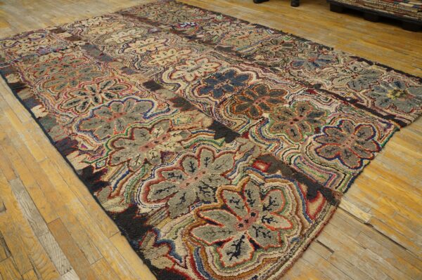 Polychromatic high-pile rug with gray and tan floral motifs displayed on distressed light wooden planks.
