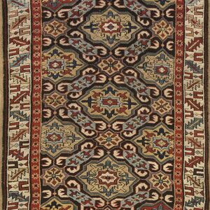 Traditional narrow rug with repeating medallion patterns in black, tan, red, and slate blue colors.