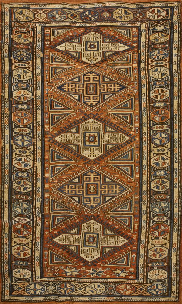 Geometric flatweave runner featuring interlocking diamond motifs in orange, blue, and natural tan colors.