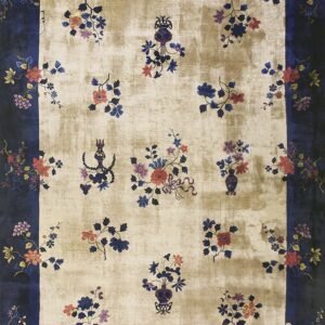 Low-pile beige rug framed by a dark navy border, patterned with ornate multicolor floral clusters.