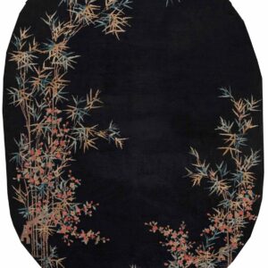 Black oval rug featuring asymmetric botanical pattern of tan and teal bamboo and coral flowers.