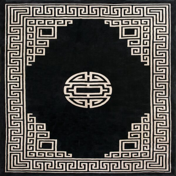 Black rug with a light geometric border, interlocking key pattern, and a circular center design.