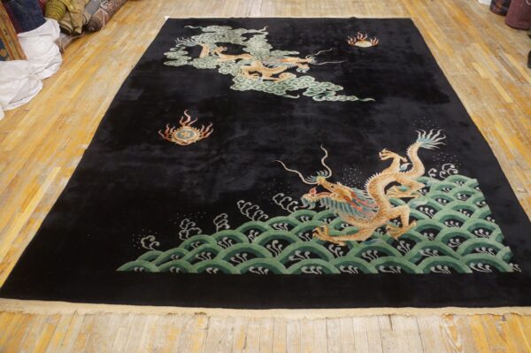 Dark plush rug featuring two golden dragons and green waves laid out on wood flooring.