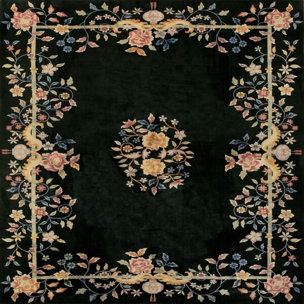 Black rug with a pink, yellow, and blue floral border and center medallion design.