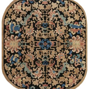 Black lobed rug with dense floral patterns in tan, blue, and coral, featuring a tan outer border.