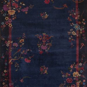 Navy blue rug with multicolored botanical, bird, and figurine patterns concentrated near the frame.