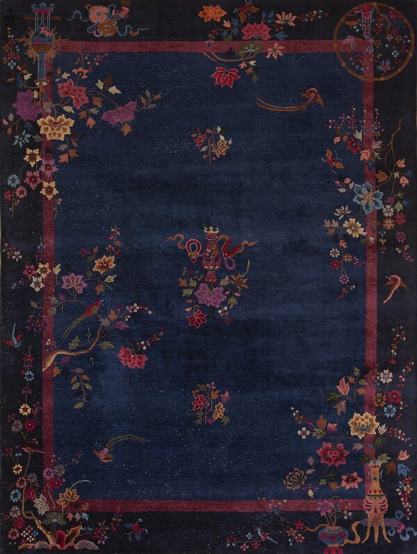 Navy blue rug with multicolored botanical, bird, and figurine patterns concentrated near the frame.