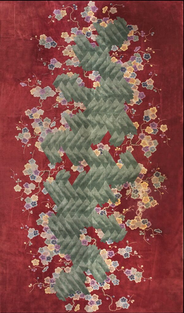 Deep red rug with lush multicolored flowers surrounding a prominent carved green chevron motif.